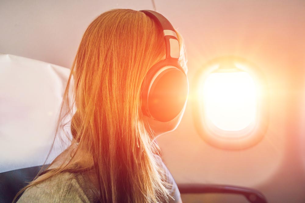 woman in airplane, overcoming fear of flying with meditation